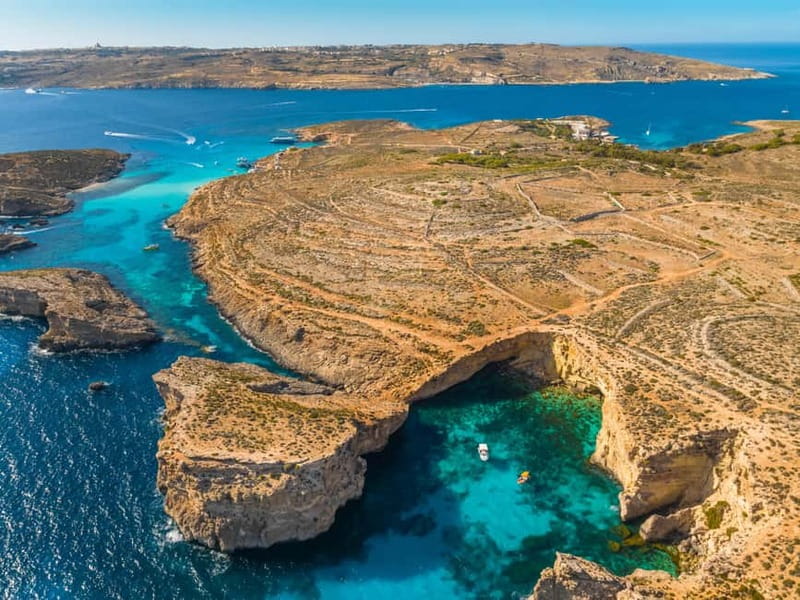 Comino: Blue Lagoon, Crystal Lagoon and Sea Caves Boat Tour - First views of Comino and the historic tower