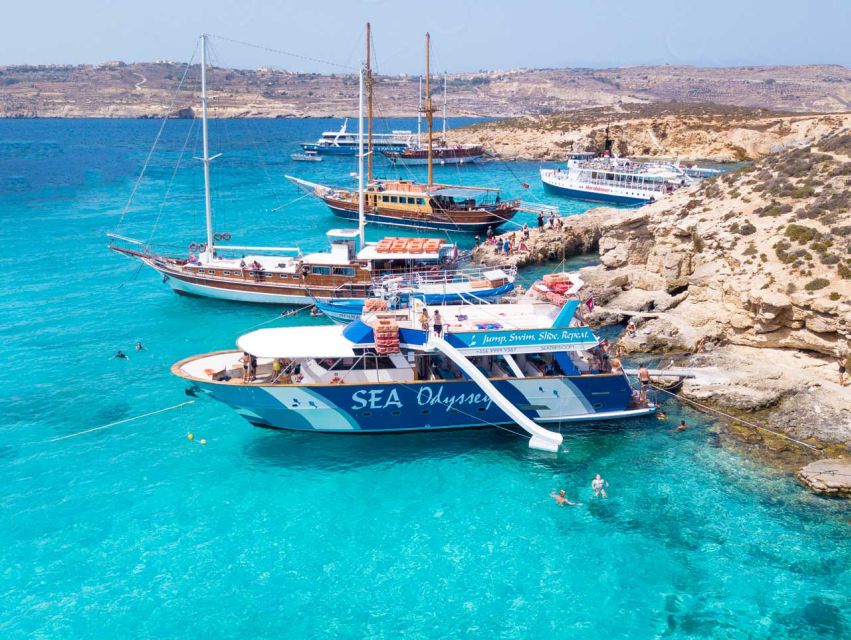 Boats moored in the turquoise shallows of the Blue Lagoon at Comino