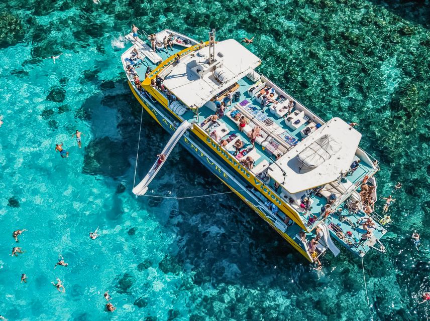 From Bugibba: Blue Lagoon Afternoon Swim with Sunset Cruise - Waterslide, loungers, and life aboard the boat