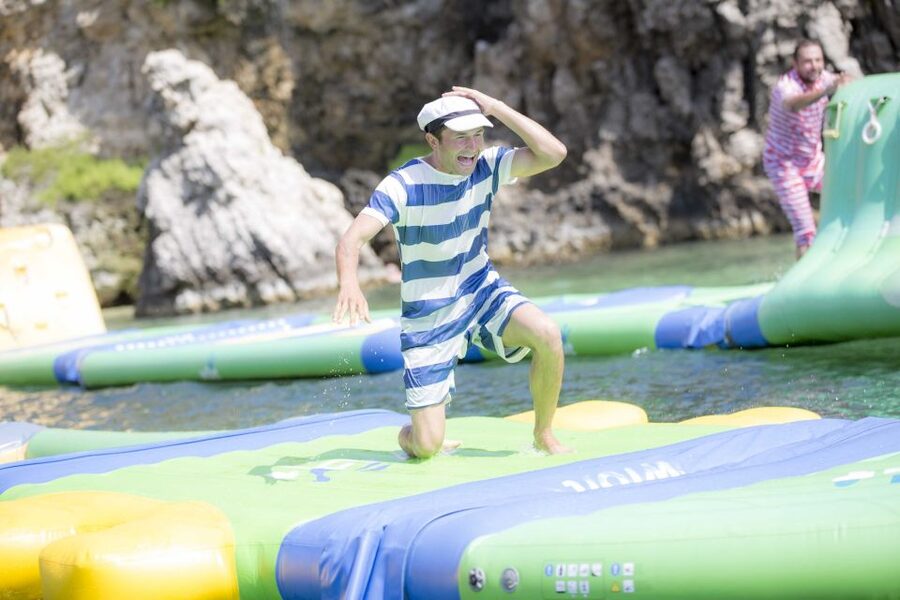 Mellieha: Popeye Village with Optional Private Transfers - Swimming at Anchor Bay in summer